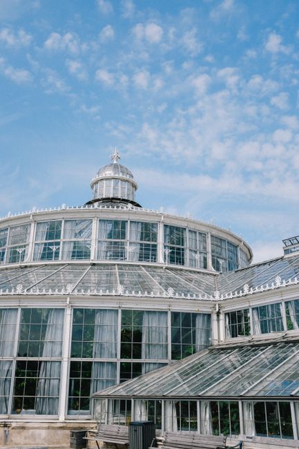 The image features the dome of the Horniman Museum, showcasing its classic glass and metal structure with multiple curved glass panels and intricate detailing along the roofline. The sky above is brig